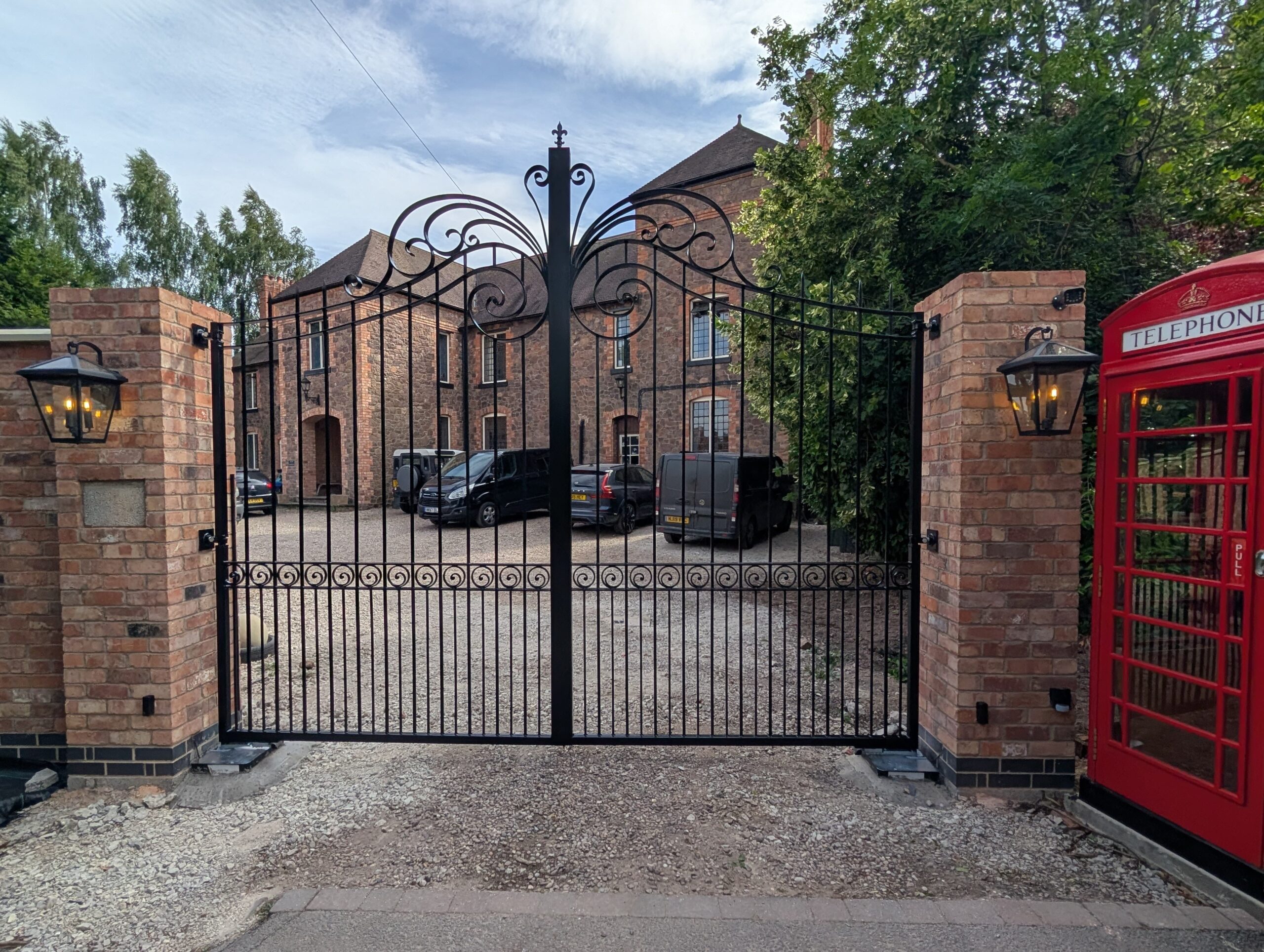 Bespoke hand forged iron driveway gates, full automated system with induction loop and intercom system.